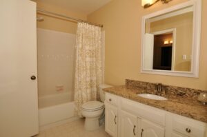 Master bath with updated granite brown counters, new mirror, new sink and new faucet